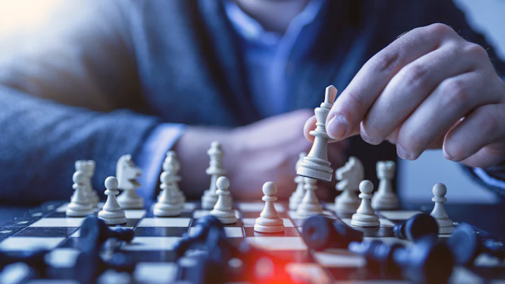 A person planning a move in a game of chess