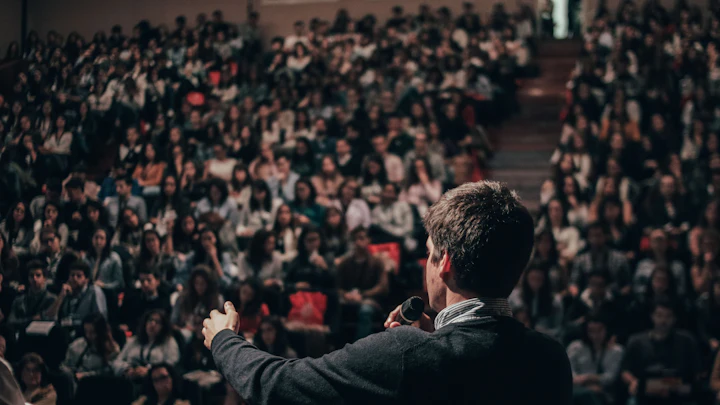 A man speaking to a seated audience