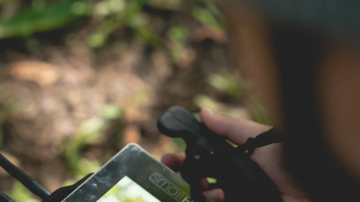 A hand holding a phone playing a vertical video