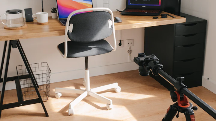 A camera on a tripod set up on a wooden table