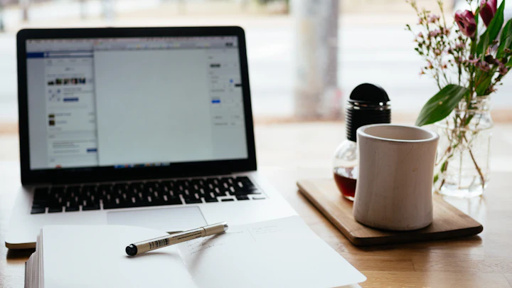 Laptop and notepad on a desk
